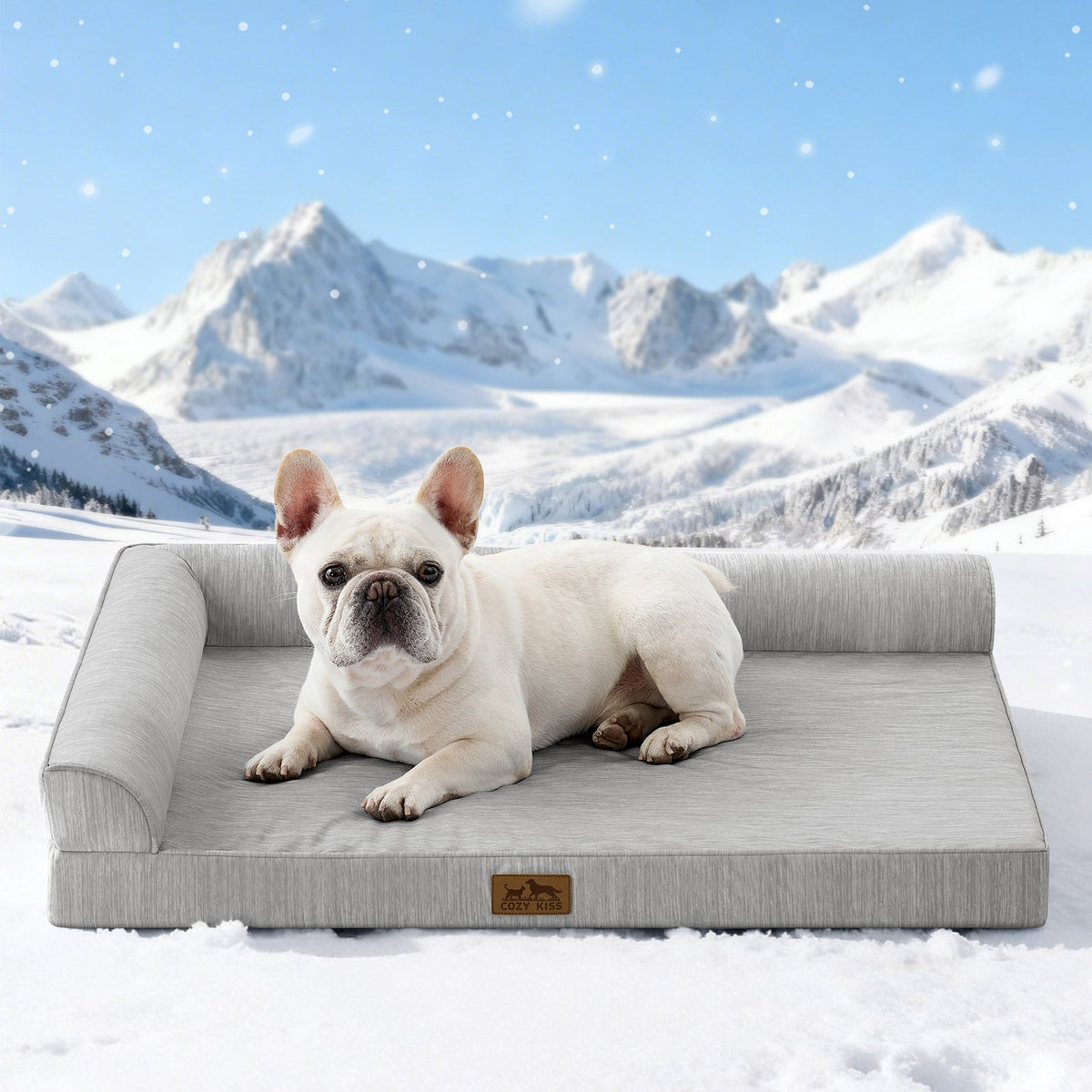 Dog lying on Cozy Kiss grey pet bed with a snowy mountain landscape in the background