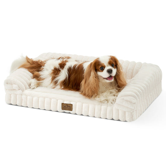 Dog lying on Cozy Kiss Striped Faux U-Shaped Washable Dog Bed, showing raised bolsters and soft striped texture. #color_Cream