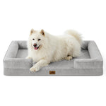 White dog lying on a gray pet bed with a white background
