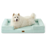 White dog lying on green pet bed