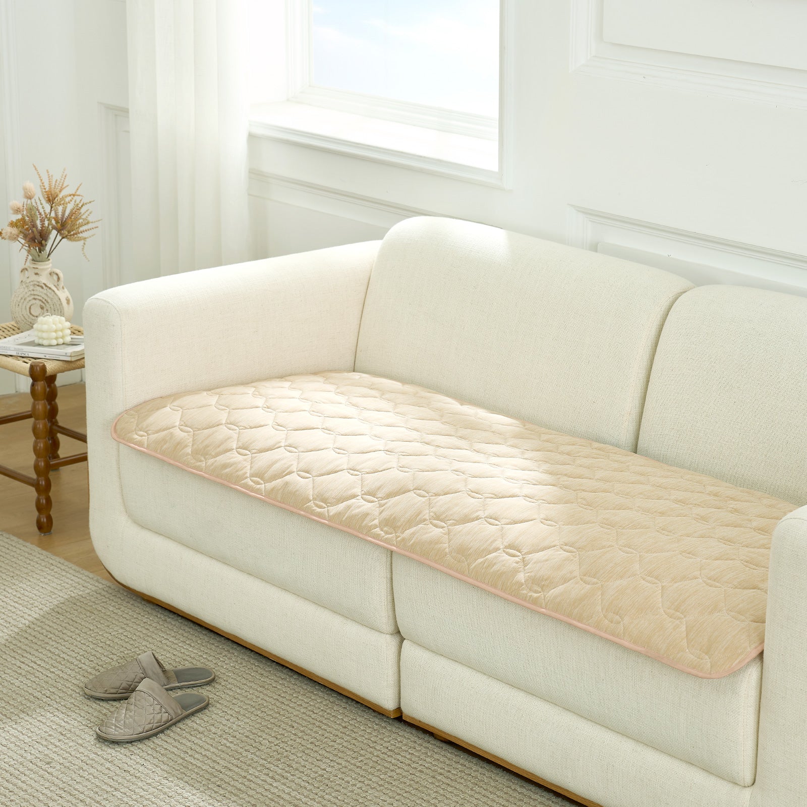 Beige couch cover on a white sofa in a living room setting.#Color_Beige