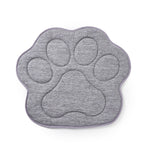 Gray paw-shaped mat on a white background.
