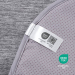 Oeko-Tex label on gray paw-shaped cooling pet mat fabric.