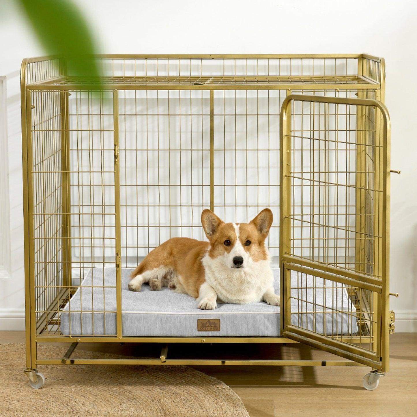 Dog lying on a cooling cushion inside a gold metal dog crate.#color_Grey