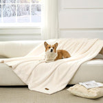 Cozy Kiss Leakproof Faux Fur Pet Blanket in Cream White front view with a dog sitting on it. 