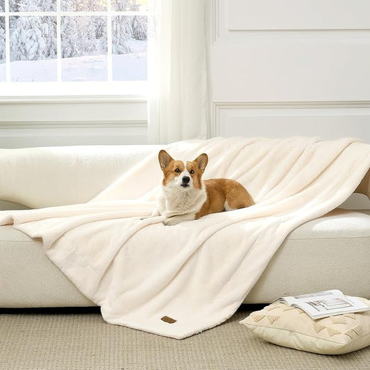 Cozy Kiss Leakproof Faux Fur Pet Blanket in Cream White front view with a dog sitting on it. #color_Cream White