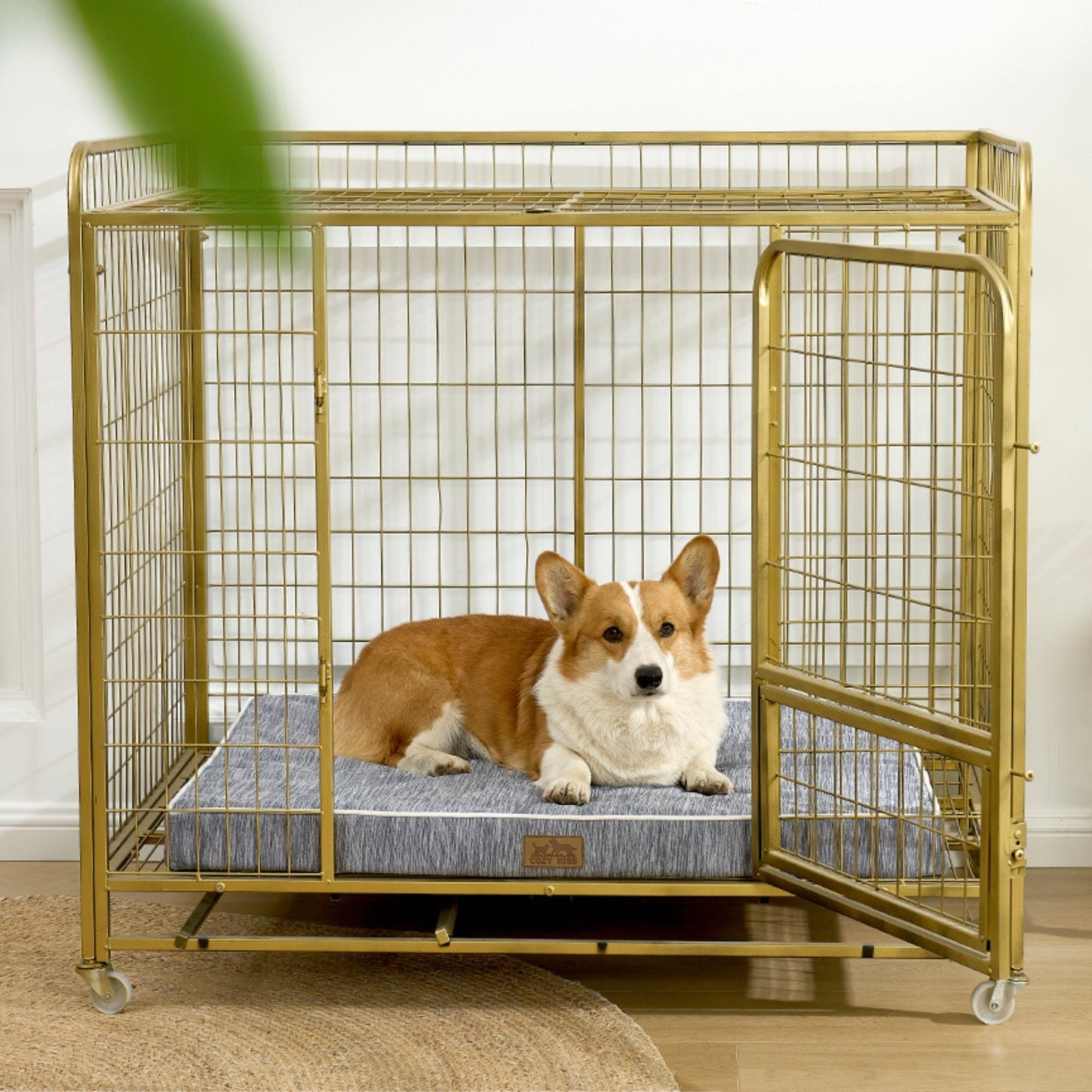 Dog lying on a cooling cushion inside a gold metal dog crate.#color_Dark Grey